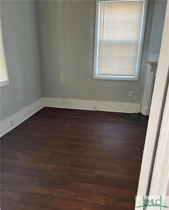 spare room with dark wood-type flooring