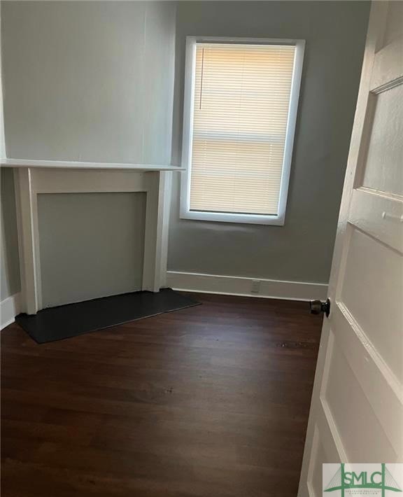 spare room with dark hardwood / wood-style flooring