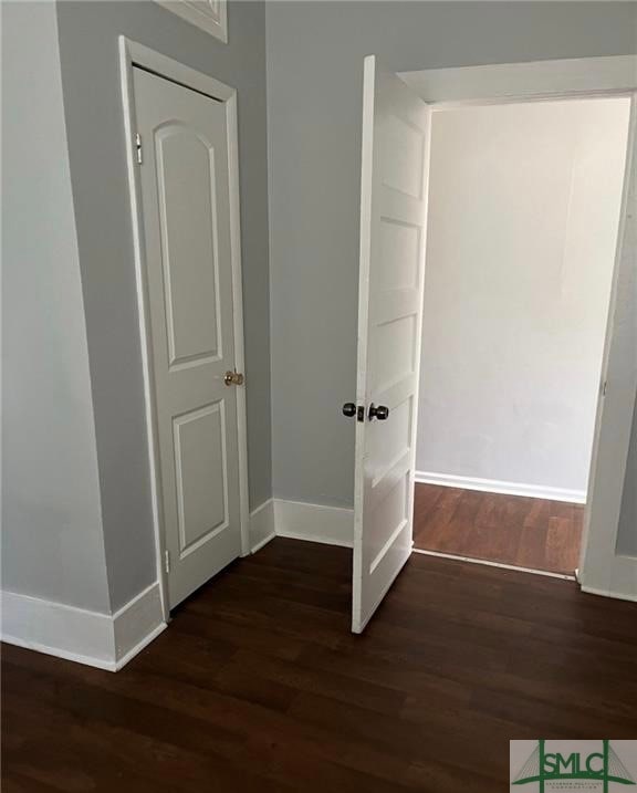 hall with dark hardwood / wood-style floors