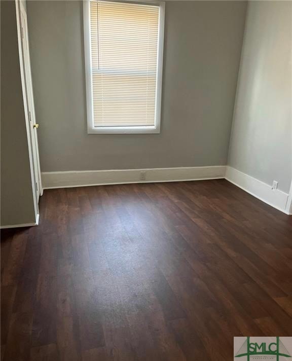 empty room with dark wood-type flooring