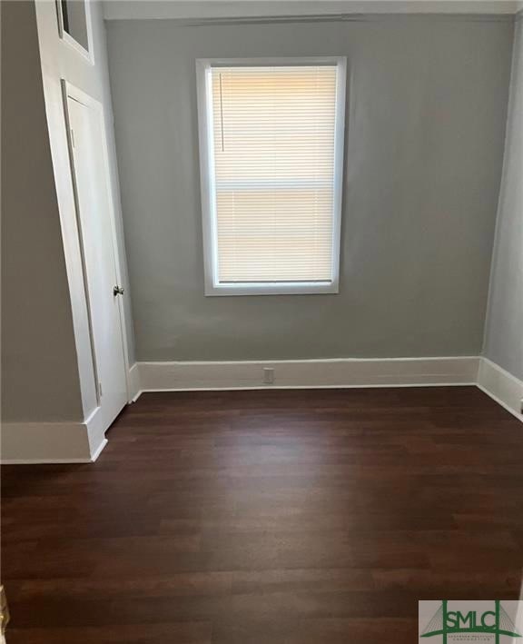 unfurnished room with dark hardwood / wood-style floors and a healthy amount of sunlight