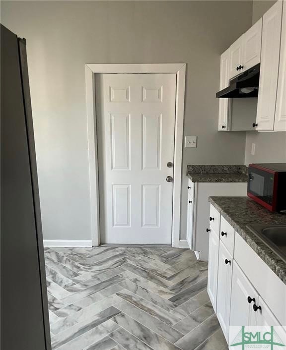 kitchen featuring white cabinets