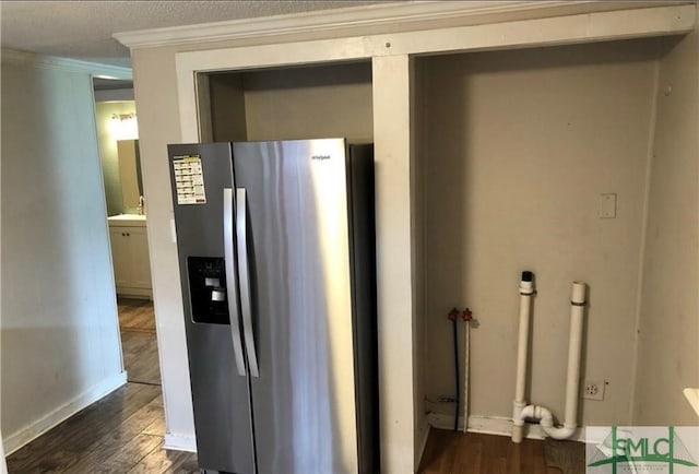 kitchen featuring ornamental molding, dark hardwood / wood-style floors, and stainless steel fridge with ice dispenser