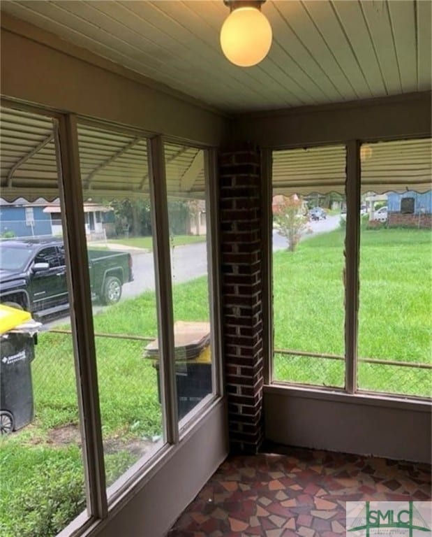 unfurnished sunroom featuring wood ceiling