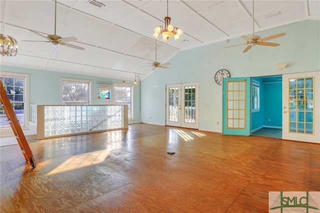 unfurnished living room with french doors, hardwood / wood-style floors, and ceiling fan with notable chandelier