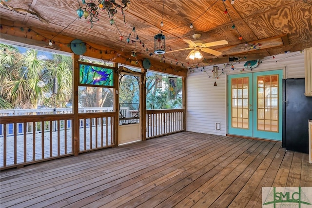 unfurnished sunroom with french doors, wood ceiling, and ceiling fan