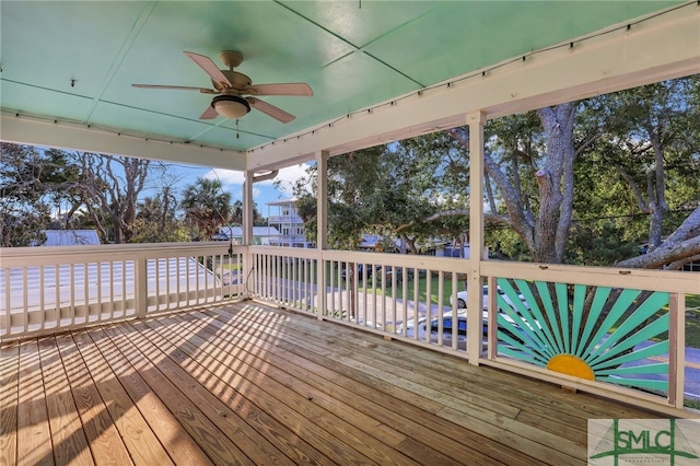 wooden deck featuring ceiling fan