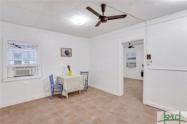 dining room with cooling unit and a textured ceiling