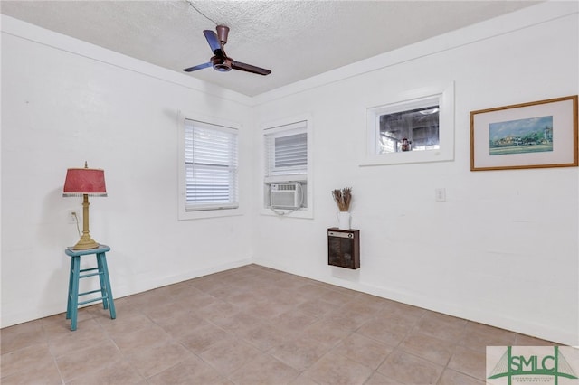 unfurnished room with cooling unit, a textured ceiling, and ceiling fan