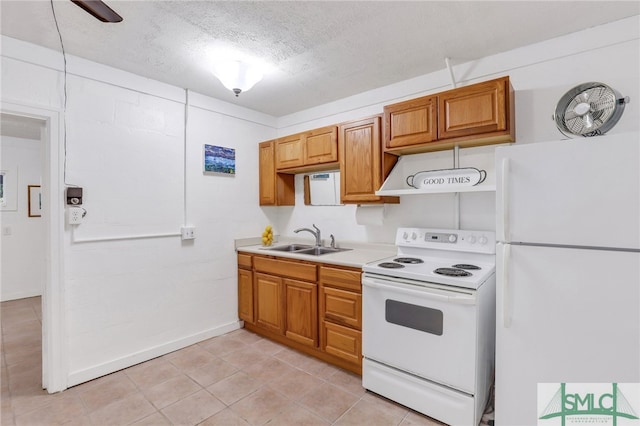 kitchen with white appliances, light tile patterned floors, a textured ceiling, and sink