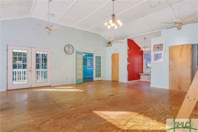 unfurnished living room with french doors, wood-type flooring, ceiling fan with notable chandelier, and vaulted ceiling