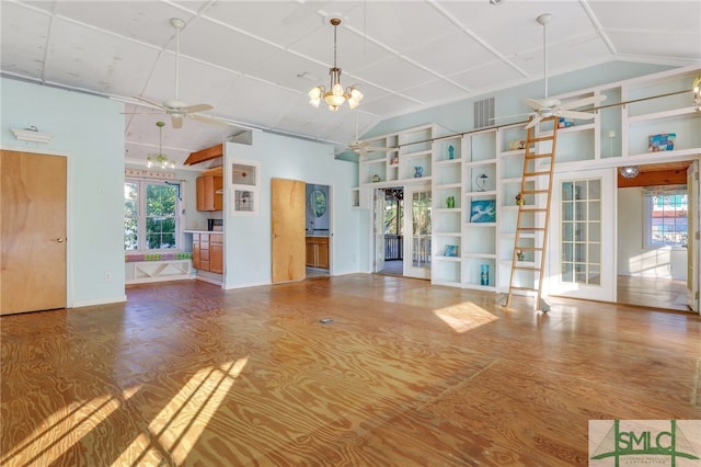 unfurnished living room with lofted ceiling, french doors, hardwood / wood-style flooring, and ceiling fan with notable chandelier