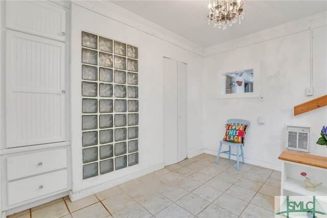 interior space with ornamental molding, light tile patterned floors, and a chandelier