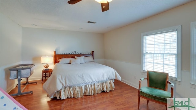 bedroom with ceiling fan and light hardwood / wood-style flooring