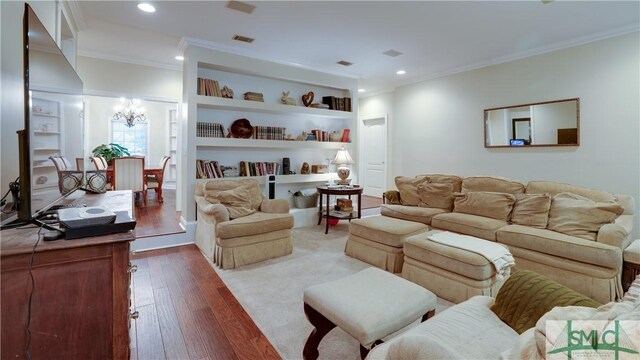 living area with a notable chandelier, recessed lighting, crown molding, and wood-type flooring