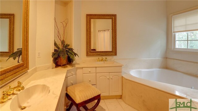 bathroom featuring vanity, a bath, and tile patterned flooring