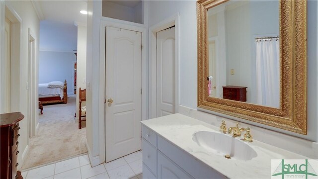 full bath featuring tile patterned flooring, vanity, and ensuite bathroom