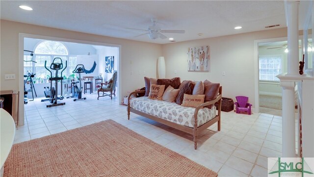 tiled living room featuring ceiling fan