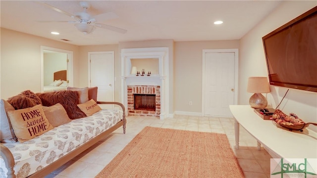 living room with a brick fireplace and ceiling fan