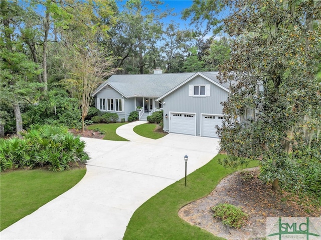 view of front of house with a garage and a front lawn