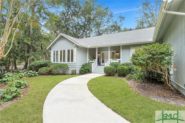 ranch-style house with covered porch and a front yard