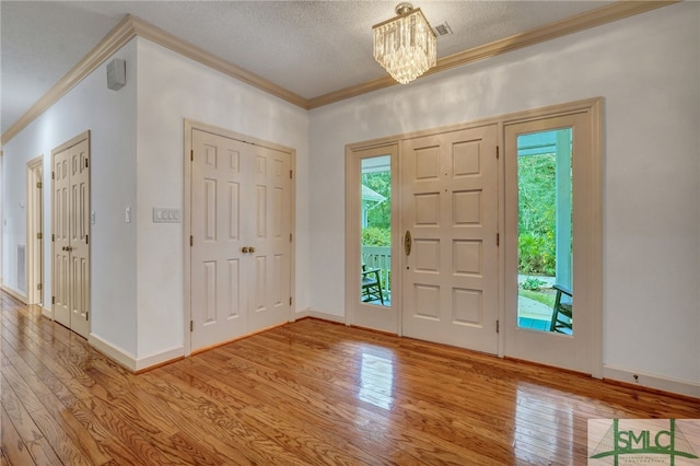 foyer entrance featuring a wealth of natural light and light hardwood / wood-style flooring