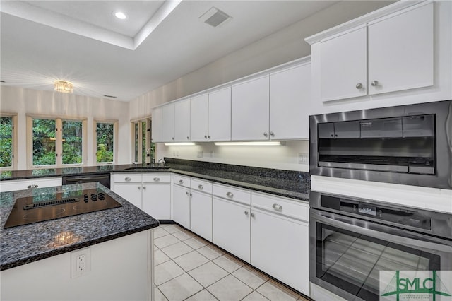 kitchen featuring appliances with stainless steel finishes, white cabinetry, sink, and light tile patterned floors