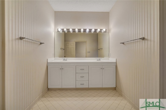 bathroom with vanity, a textured ceiling, and tile patterned floors