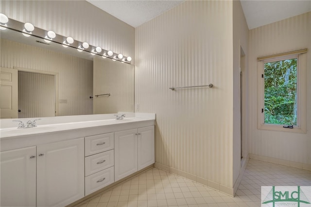 bathroom with vanity, tile patterned floors, and a textured ceiling