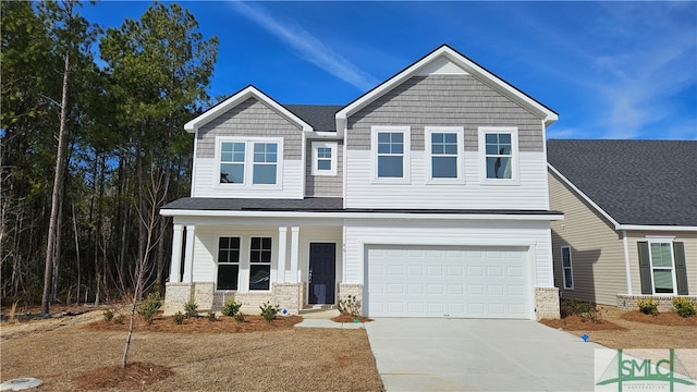 view of front of home with a porch and a garage