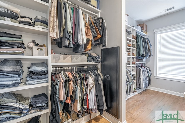 walk in closet with wood finished floors and visible vents