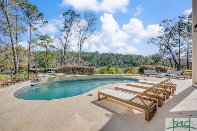 view of pool featuring a patio area and an in ground hot tub