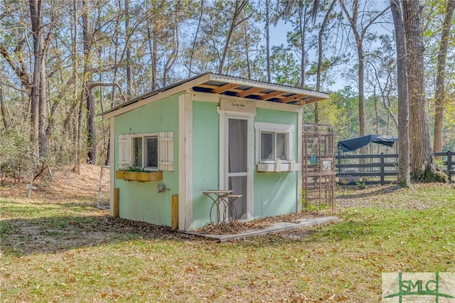 view of outbuilding featuring a lawn