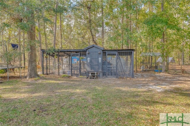 579 Turkey Trot Trl, Richmond Hill, GA 31324 - view of poultry coop with a trampoline and a lawn