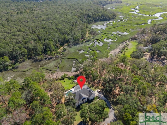 aerial view with a water view and a forest view