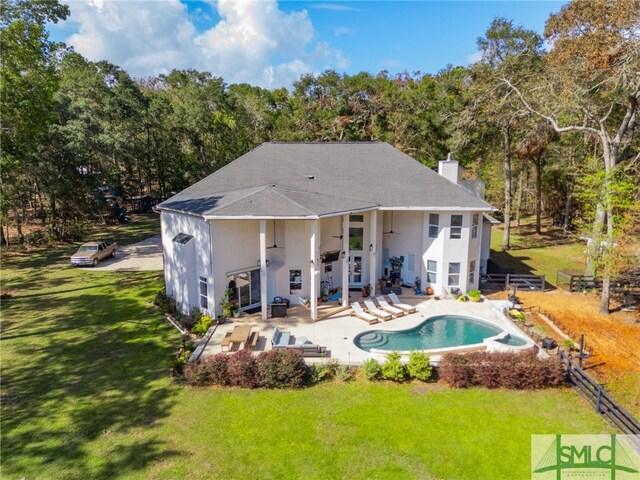 rear view of property featuring an outdoor living space, a patio, ceiling fan, and a lawn