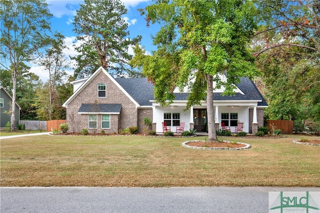 craftsman-style home featuring a porch and a front lawn