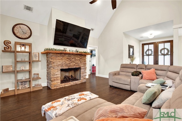 living room featuring french doors, a stone fireplace, ceiling fan, dark wood-type flooring, and high vaulted ceiling