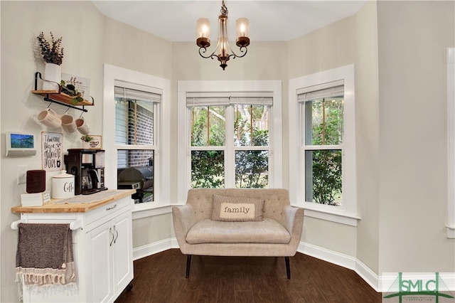 sitting room with a chandelier and dark hardwood / wood-style floors