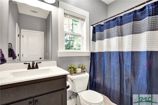 bathroom with vanity, toilet, and a shower with shower curtain