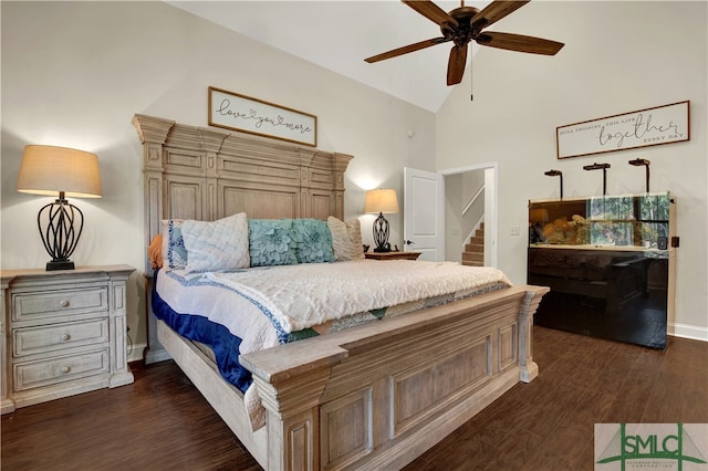 bedroom featuring dark hardwood / wood-style floors, high vaulted ceiling, and ceiling fan