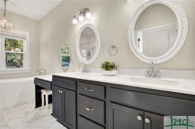 bathroom featuring vanity, a notable chandelier, and a washtub