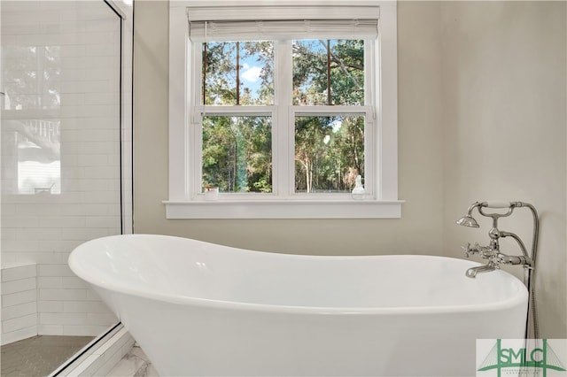 bathroom featuring independent shower and bath