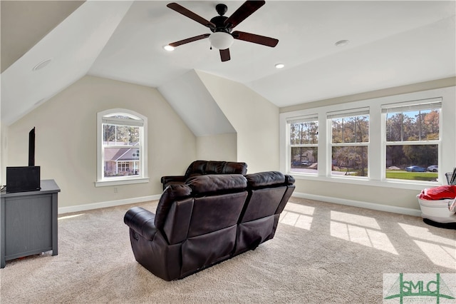 carpeted living room with lofted ceiling and ceiling fan