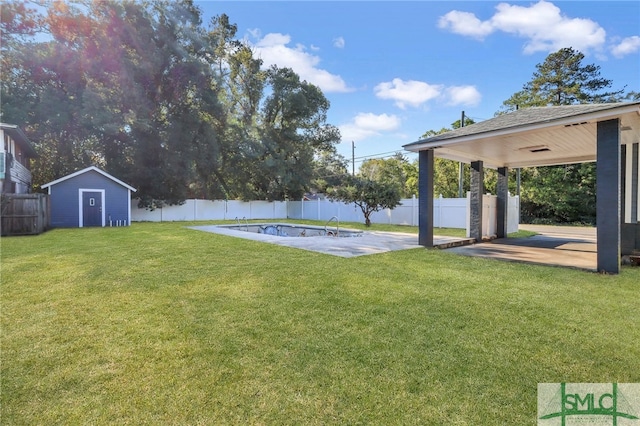 view of yard with a patio, a fenced in pool, and a storage unit