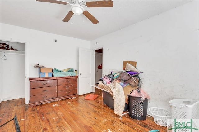 interior space with a closet, light hardwood / wood-style floors, and ceiling fan