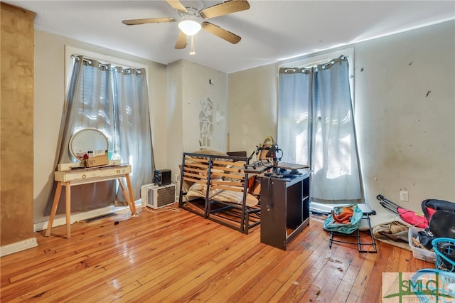 misc room featuring wood-type flooring and ceiling fan