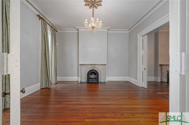 unfurnished living room featuring wood finished floors, baseboards, a fireplace with flush hearth, and ornamental molding