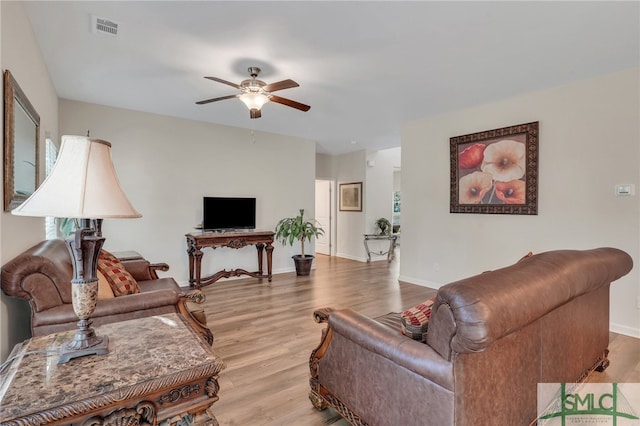 living room with ceiling fan and light hardwood / wood-style floors