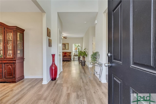 foyer featuring light wood-type flooring and ceiling fan